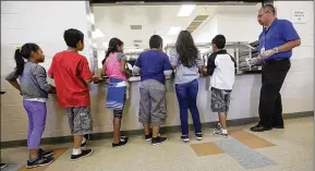  ?? ERIC GAY/2014 AP FILE ?? Immigrant children line up in the cafeteria at the Karnes County Residentia­l Center, a detention center for immigrant families, in Karnes City, Texas.