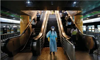  ?? ?? A worker in a protective suit cleans the floor at a subway station, after the Covid lockdown was lifted in Shanghai. Photograph: Aly Song/ Reuters