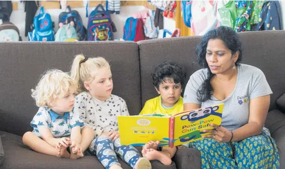  ?? Picture / Jason Oxenham ?? Rachel Ravoor reads a gun-safe book to Jay Davidson, 2, Bonnie Davidson, 4, and Aadi Sharma, 3, at Pascals Herne Bay centre.