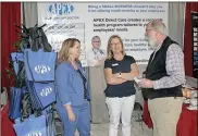  ?? / Doug Walker ?? Stephanie Trautman (from left) and Jamie Jackson of APEX Direct Care talk with Len Willingham at the Chamber Business Expo on Friday.