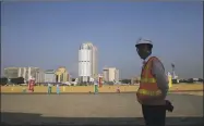  ?? Associated Press file photo ?? A Chinese constructi­on worker stands on land that was reclaimed from the Indian Ocean for the Colombo Port City project, initiated as part of China’s ambitious One Belt One Road initiative, in Colombo, Sri Lanka in 2018.