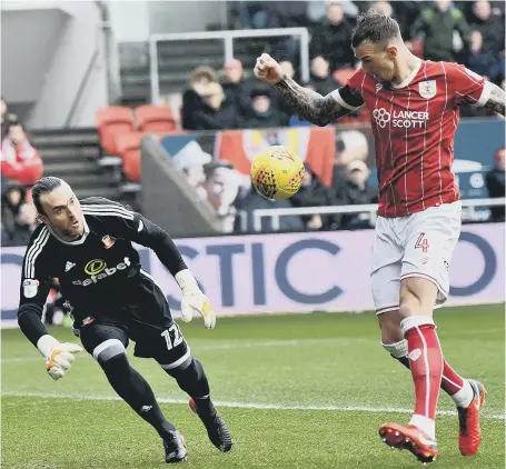  ??  ?? Sunderland keeper Lee Camp prepares to try to deny Aden Flint as the defender scores Bristol City’s first goal last week. Picture by Frank Reid
