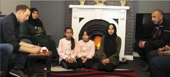  ??  ?? Reporter David Looby interviewi­ng the Aljasim family at their home in New Ross.