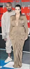  ?? Jordan Strauss Invision / Associated Press ?? KIM KARDASHIAN wears Balmain; Kanye West, sweats.