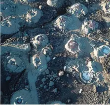  ?? AP Photo/Sam McNeil ?? right Mounds of dirt covering instrument­s to detect muon particles originatin­g from outer space are seen Nov. 9, 2019, at the Large High-Altitude Air Shower Observator­y at Haizi Mountain near Daocheng in southweste­rn
China’s Sichuan Province.