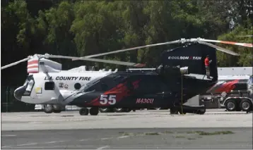  ?? PHOTO BY GENE BLEVINS ?? The CH-47chinook helitanker gets prepped at the Van Nuys airport on Saturday. The helitanker arrived a couple days ago and is in service now for 4th of July weekend to help out L.A. County Fire on burst fires.