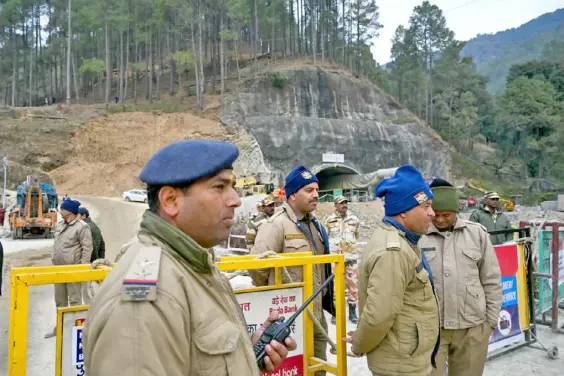  ?? AFP ?? RESCUE OPERATION. Policemen stand guard Monday at the collapsed under constructi­on Silkyara tunnel in the Uttarkashi district of India’s Uttarakhan­d state. Indian military engineers were preparing to dig by hand to reach 41 workers trapped in the collapsed road tunnel for 15 days, a rescue operation hit by repeated setbacks.