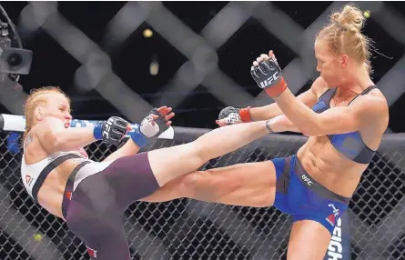  ?? NAM Y. HUH/ASSOCIATED PRESS ?? Valentina Shevchenko, left, and Holly Holm trade kicks during a women’s UFC bantamweig­ht mixed-martial arts bout Saturday in Chicago. Shevchenko won by unanimous decision.