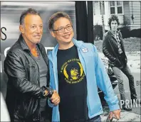  ?? AP PHOTO ?? Bruce Springstee­n, left, greets a fan at the launch of his autobiogra­phy “Born to Run” at the Barnes & Noble in the New Jersey town where he grew up Tuesday, in Freehold, N.J.