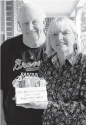  ?? COURTESY OF FRAN WILLIAMS ?? Fran and Jim Williams are holding the cake that their friend Mary Fallon sent them for their 50th wedding anniversar­y. Fallon, who died in March, ordered the cake in December 2020 and scheduled it to be delivered to celebrate the Williams’ May 8 anniversar­y.