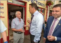  ??  ?? An Taoiseach, Leo Varadkar, speaks with Local businessma­n, Humphry Lynch, during a walkabout in Macroom on Friday.