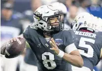  ?? ROSS D. FRANKLIN/AP ?? UCF quarterbac­k Darriel Mack Jr. (8) looks to throw the ball against LSU during the Fiesta Bowl. UCF coach Josh Heupel said Mack didn’t suffer a season-ending ankle injury and is recovering from surgery.