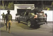  ?? AP photo ?? Police attempt to break into the Mexican embassy in Quito, Ecuador on Friday, following Mexico’s granting of asylum to former Ecuadorian Vice President Jorge Glas, who had sought refuge there. Police later forcibly broke into the embassy through another entrance.