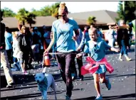  ?? COURTESY PHOTOGRAPH ?? Second-grade teacher Mrs. Anderson runs with her daughter, a third grader, and their family pup.
