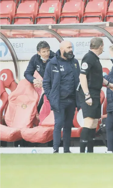  ??  ?? Referee Trevor Kettle speaks with the two benches during Good Friday's heated League One game between