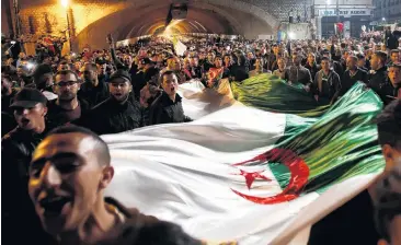  ?? PHOTO: REUTERS ?? People carry a national flag as they celebrate on the streets after Algeria’s President Abdelaziz Bouteflika has submitted his resignatio­n, in Algiers last week.