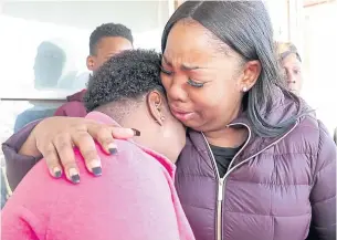  ??  ?? Bernice Parks, left, is consoled by Jasmine Wells, Sandra Parks’ godmother, after the mother talked about 13-year-old Sandra who was killed in her bedroom by a stray bullet.