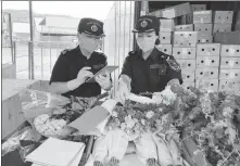  ?? ZHANG XINYUE / FOR CHINA DAILY ?? Customs officials inspect flower exports at the Mohan land port in Yunnan province in July.