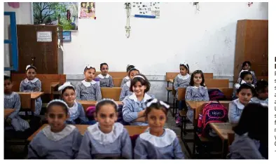  ??  ?? Ready to learn: Palestinia­n schoolgirl­s sitting inside a classroom at an UNRWA-run school, on the first day of a new school year, in Gaza City. — Reuters