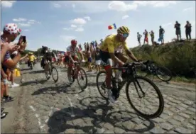  ?? CHRISTOPHE ENA — THE ASSOCIATED PRESS ?? Belgium’s Greg van Avermaet, wearing the overall leader’s yellow jersey, is followed by stage winner Germany’s John Degenkolb, and Belgium’s Yves Lampaert during the ninth stage of the Tour de France on July 15 in Roubaix, France.