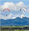  ??  ?? Paraglider­s at Back Beach.