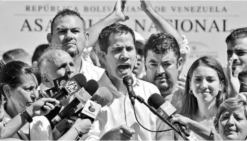  ??  ?? Guaido speaks before a crowd of opposition supporters during an open meeting in Vargas, Venezuela. — AFP photo