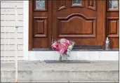  ?? JULIUS CONSTANTIN­E MOTAL — THE ASSOCIATED PRESS ?? Flower bouquets rest on the doorstep of a rabbi’s residence in Monsey, N.Y., Sunday following a stabbing Saturday night during a Hanukkah celebratio­n.