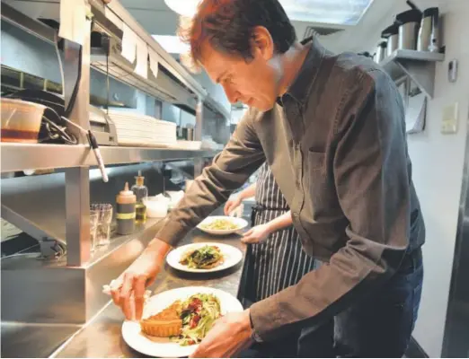  ??  ?? Kimbal Musk helps chef David Engel at Musk’s restaurant The Kitchen in Boulder in February.