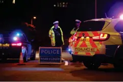  ?? (Reuters) ?? Police officers and their vehicles close off a road after reported multiple stabbings in Reading