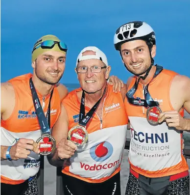  ?? Picture: WERNER HILLS ?? FAMILY AFFAIR: Twins Phillip, left, and Timothy Heine, right, from Port Elizabeth completed the Standard Bank Ironman African Championsh­ip for the first time with their father, Roy