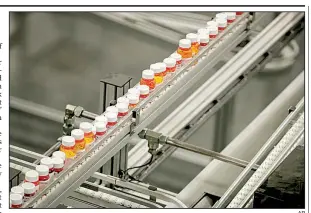  ?? AP ?? Bottles of medicine ride on a conveyor belt last year at the Express Scripts mail-in pharmacy warehouse in Florence, N.J. Democrats in Congress who are considerin­g a revamped North American trade pact contend that it would raise prescripti­on drug prices in the U.S.