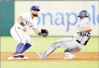  ?? (AFP) ?? Rougned Odor #12 of the Texas Rangers waits for the throw as Danny Valencia #26 of the Seattle Mariners steals
second in the sixth inning of a game at Globe Life Park in Arlington on Sept 11 in Arlington, Texas.