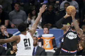 ?? GERRY BROOME — THE ASSOCIATED PRESS ?? Team LeBron’s LeBron James shoots over Team Giannis’ Joel Embiid of the Sixers during the second half of the NBA All-Star game Sunday in Charlotte, N.C.