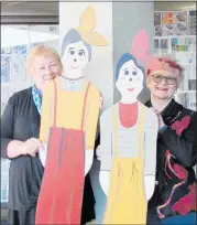  ??  ?? GROUP members Carol Mason and multi media artist Paulette Robinson, with figurines created to go outside the Arty Tarts new store.