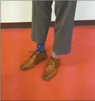  ?? Tricia Cambron/SJ ?? State Rep. Trey Kelley (R-16th District) shows off a pair of American flag socks, one of the many different pairs he wore during the 2015 legislativ­e session.