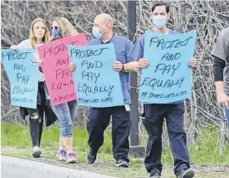  ?? TONY CALDWELL/POSTMEDIA NEWS ?? CUPE members at Ottawa’s Queensway Carleton Hospital protested what they say is the unfair distributi­on of pandemic pay at this May 17 rally.