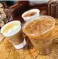  ??  ?? Black Rifle Coffee Co. on Bitters Road offers iced horchata latte, front, cappuccino, left, and chai latte.