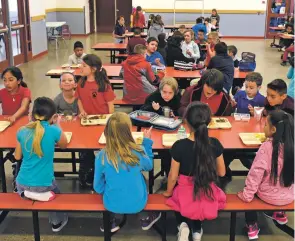  ?? NEW MEXICAN FILE PHOTO ?? Third-grade students have lunch in the Gonzales Community School cafeteria in 2017. Some schools across the nation that see a high number of parent visits during the lunch hour are considerin­g a blanket ban.