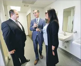  ?? Photograph­s by Al Seib Los Angeles Times ?? LOS ANGELES Mayor Eric Garcetti, center, visits the Skid Row Community ReFresh Spot with Bruce Boardman, left, and Zelenne Cardenas.