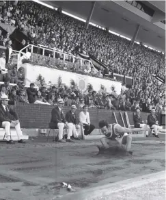  ??  ?? 0 Wales’ Lynn Davies completes his long jump to take gold