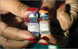  ?? ROGELIO V. SOLIS / AP FILE ?? A nurse holds a vial of the Pfizer COVID-19 vaccine for children ages 5 to 11, right, and a vial of the vaccine for adults, which has a different colored label, at a vaccinatio­n station in Jackson, Miss., on Feb. 8. U.S. regulators authorized a COVID-19 booster shot for healthy 5- to 11-year-olds on Tuesday, hoping an extra vaccine dose will enhance their protection as infections once again are on the rise.