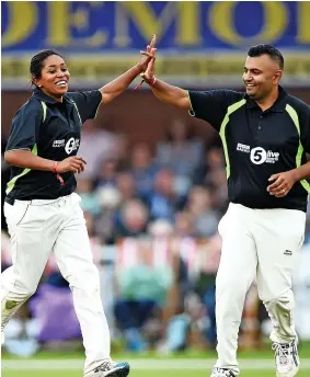  ?? GETTY IMAGES ?? CELEBRATIO­N: Nikesh Rughani of TMS with former England player Ebony Rainford-Brent after taking a wicket in the Radio 5 Live cricket match between TMS and Tailenders at Derby in August 2018