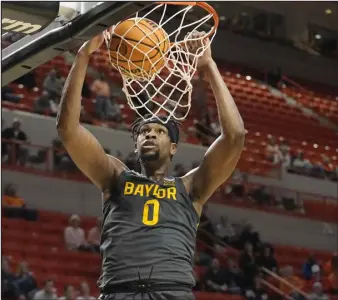  ?? SUE OGROCKI — THE ASSOCIATED PRESS ?? Baylor forward Flo Thamba dunks in the second half of a game against Oklahoma State on Feb. 27 in Stillwater, Okla.