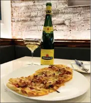  ?? COURTESY GRAND TOUR ?? Grand Tour chef Michael Serpa brings a taste of Alsace to Boston, with a Tarte Flambee paired with wines from Trimbach.