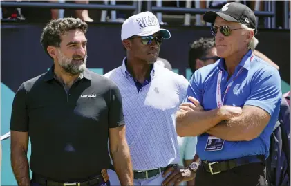  ?? SETH WENIG — THE ASSOCIATED PRESS FILE ?? Yasir Al-Rumayyan, left, governor of Saudi Arabia’s Public Investment Fund, Majed Al-Sorour, CEO of Golf Saudi, center, and Greg Norman, CEO of LIV Golf, watch at the first tee during the second round of the Bedminster Invitation­al LIV Golf tournament in Bedminster on July 30, 2022.