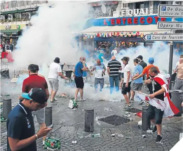  ??  ?? ■
The French police keep the England fans on a tight rein in Marseille.