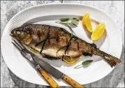  ?? LAURA CHASE DE FORMIGNY FOR THE WASHINGTON POST ?? Grilled trout with sage, mint and lemon. Grilling the whole fish ensures that it comes out flakier and is less likely to be overdone.