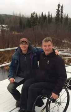  ?? THE RICK HANSEN FOUNDATION ?? Mike Tudor, of the Gavin Lake Forest Education Centre, gives Rick Hansen a tour of the accessible Gavin Lakeshore Trail in B.C.