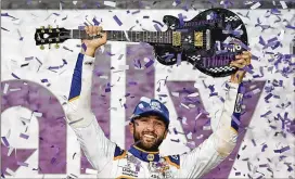  ?? MARK HUMPHREY/ASSOCIATED PRESS ?? Chase Elliott holds the guitar trophy presented to him after winning the NASCAR Cup Series race Sunday night at Nashville Superspeed­way.