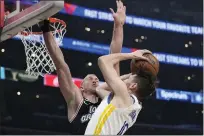  ?? MARK J. TERRILL — THE ASSOCIATED PRESS ?? Warriors guard Ty Jerome, right, shoots as Los Angeles Clippers center Mason Plumlee defends during a game Tuesday, in Los Angeles.